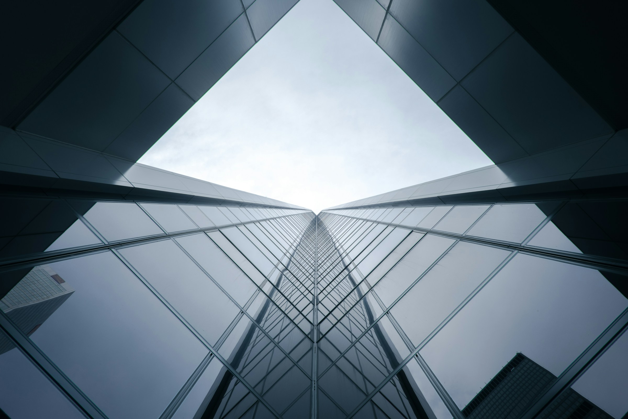 前瞻科技研究中心 ([worms eye view of building during daytime Glass building] by [Verne Ho], YEAR:2015. Source: [unsplash.com].)